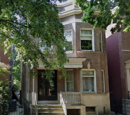 1113 W. Drummond Place, c.1890, Lincoln Park. A two-story brick two-flat with a projecting bay, bracketed cornice, stone lintels and a wood entry porch with turned posts. Demolished August 2026. Photo credit: Google Maps