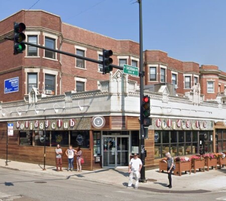 4000-4006 N. Sheridan Road and 1002-1016 W. Irving Park Road, c.1915, Uptown. A three-story red brick apartment block wrapping the corner above a continuous white terra cotta storefront, longtime home of the Holiday Club. Demolished August 2026. Photo credit: Google MapsTHREATENED: Demolition Looms for Ornate Terra Cotta Holiday Club Building (Chicago 7 2023); Preservation ChicagoFull Permit Issued For 91 Units At 4006 North Sheridan, But Demolitions Still Pending, Daniel Schell, Chicago YIMBY, 8/16/26
