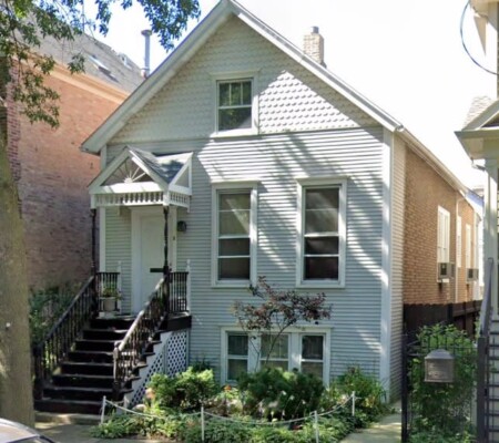 1308 W. Nelson Street, c.1890, Lake View. A frame gable-front cottage with fish-scale shingles in the gable, a pedimented entry hood on turned brackets and a boxed bay window. Demolished August 2026. Photo credit: Google Maps